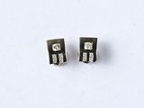 pair of black and white diamond stud earrings on a white surface