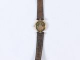 wrist watch on a white surface with a white background
