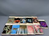 a set of six books on a table with a gray background