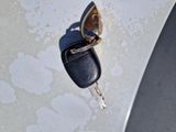 a car key that is sitting on the hood of a car