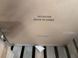 a cardboard box with a label on it sitting on a pallet