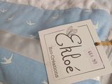 a blue and white blanket with a tag on it