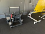 two machines that are sitting on the floor in the gym