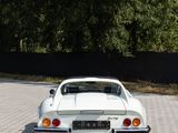a white car that is parked on the side of the road