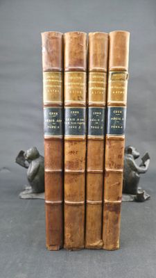 three books are stacked on top of each other on a table