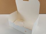 a white box that has a piece of paper in it
