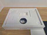 an open box with a charger on top of it on a wooden table