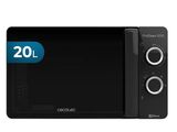 un four à micro-ondes noir posé sur un comptoir blanc
