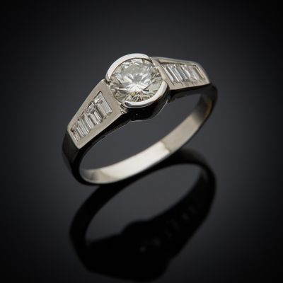 a diamond ring with baguets set in 18k white gold