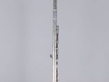 silver metal pen on a clear acrylic stand against a gray background