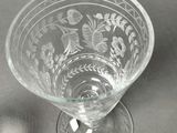 a wine glass and a mouse sitting on a table