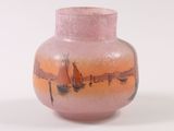 a pink vase with a picture of boats on it
