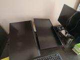 a computer desk with two monitors and a keyboard on it