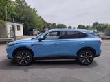 a blue suv parked in a parking lot next to a building