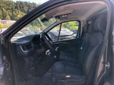 the interior of a car with the door open and the driver ' s seat down