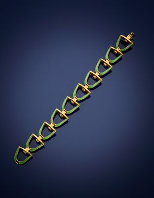 an image of a green and gold bracelet on a blue background