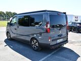 a silver van that is parked in a parking lot