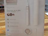 packaging of a philips soniccare electric toothbrush sitting on a wooden table
