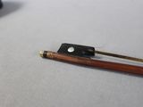 a violin bow and a bow rest on a table