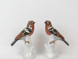 two figurines of birds sitting on top of each other