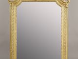 an ornate gold framed mirror on a white background