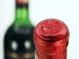 two bottles of wine sitting next to each other on a table