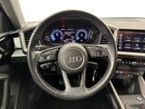the interior of a car with a steering wheel and dashboard controls