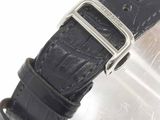 a close up of a watch with a black strap