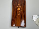 a wooden case with a design on it next to a pair of scissors