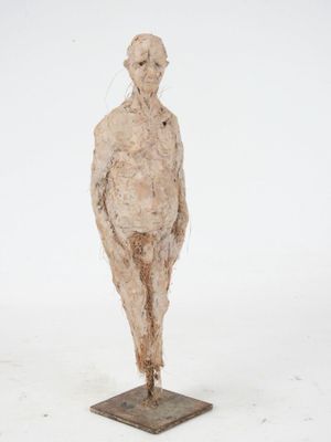 an image of a sculpture of a man standing on top of a wooden base