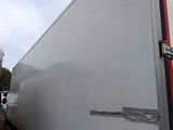 a white truck that is parked next to another truck