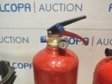 two red fire extinguisors sitting next to each other