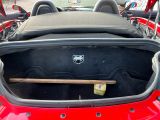 the back of a red sports car with its trunk open