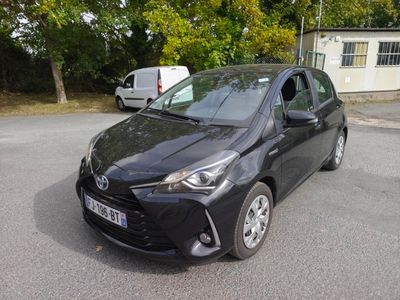 a black toyota yaris parked in a parking lot