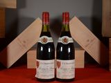 two bottles of wine sitting next to each other on a table