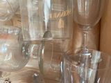 many wine glasses and a bottle on the table