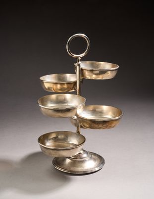 an image of a three tiered silver plate with a handle