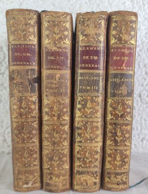 three old books sitting on top of a table next to each other
