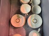many cups and saucers in a box on the table