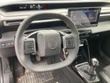 the interior of a car with a steering wheel and dashboard controls