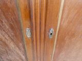 a close up of a wooden door with a metal handle