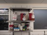 a metal shelf with various items on it in a kitchen