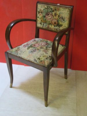 a wooden chair with a floral upholstered seat
