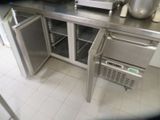 a stainless steel counter top with a refrigerator and a microwave