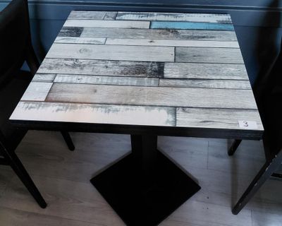 a table that has a wooden table top on it