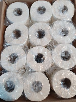many rolls of toilet paper in a box on the floor