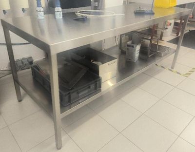 a large stainless steel table with a bunch of items on it