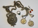 several pieces of jewelry including a coin, a necklace, and a ring
