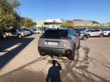 cars parked in a parking lot with a shadow of a person standing in the parking lot