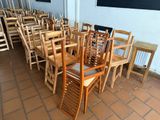 tables and chairs are lined up in a room with a chalk board
